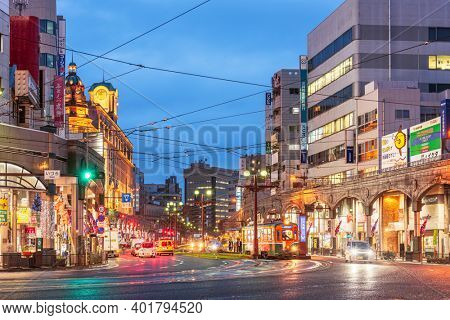 KAGOSHIMA, JAPAN - DECEMBER 10, 2015: Downtown shops and roads in Kagoshima at dusk.