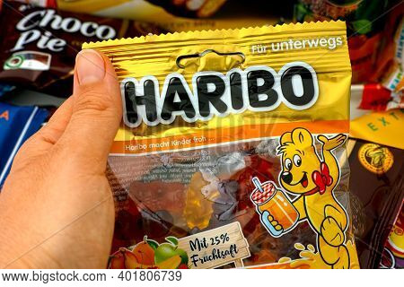 Tambov, Russian Federation - October 30, 2020 Person Hand Taking Pack Of Haribo Bears Gummy Candy. A