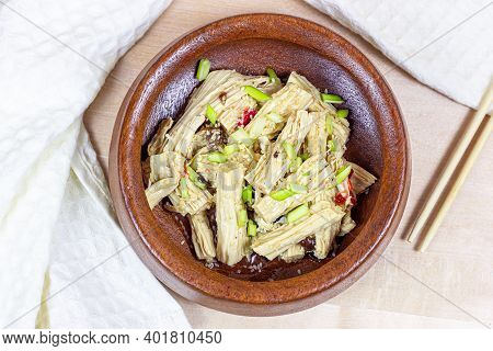 Top View Of Asian Fuzhu Salad (yuba Sticks, Soy Bean Curd, Tofu Skin) In Round Wooden Bowl On Light 