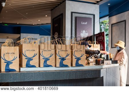 Chengdu, Sichuan Province, China - Dec 31, 2020: A Woman With Face Mask Ordering A Coffee In Luckin 