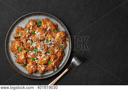 Mangalorean Chicken Sukka On Black Plate On Dark Slate Table Top. Indian Cuisine Coconut Curry Dish.