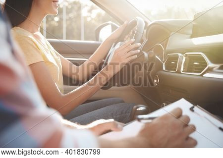 Young Woman In Car With Instructor, Closeup. Driving School