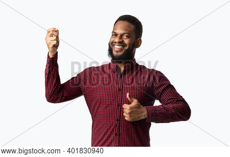Cheerful African American Guy Gesturing Thumbs Up Approving Taste Posing Smiling To Camera Standing 