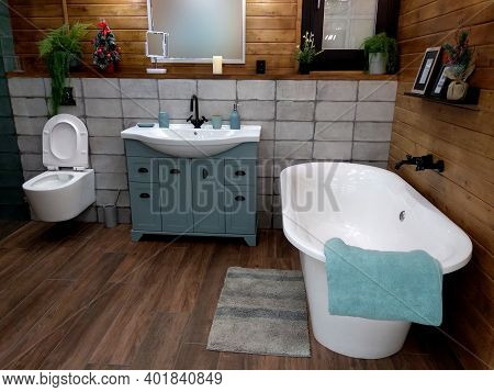 Modern Bathroom Interior With Large Bathtub. Wood And Tile Finishes.