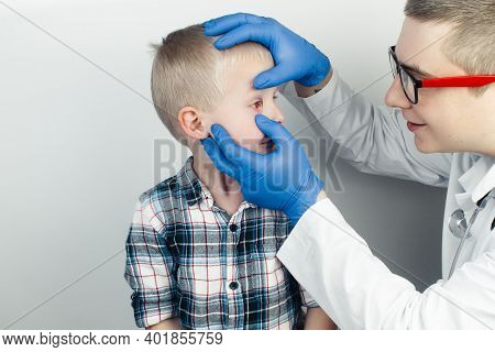 An Ophthalmologist Examines A Boy Who Complains Of Burning And Pain In His Eyes. Eye Fatigue From A