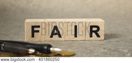 The Inscription Fair On The Texture Of Wooden Cubes On The Background Of Manet. An Inscription On A 