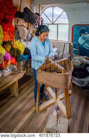 Guaranda, Bolivar Province, Ecuador - November, 2013: Woman Worker At A Humble Wool Clothing Shop, P