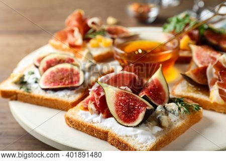 Sandwiches With Figs, Proscuitto And Cheese On Wooden Table, Closeup
