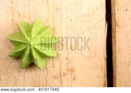 Green, Sweet, Crispy Meringue On A Wooden Background.