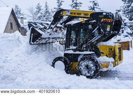 Auron, France 01.01.2021 Selective Focus. A Snow Grader Cleans Snow-covered Roads On A Ski Resort. C