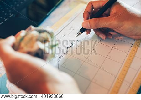 Tourist Hold Pen And Planning Vacation With Calendar And Map. Cross Line In Holiday Text And Crump P