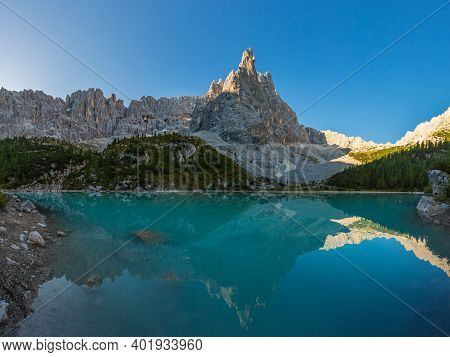 Green Water Of Sorapis Lake In Italian Dolomites With Mountain Peak And Blue Sky