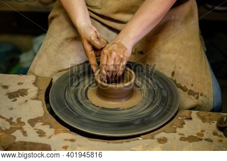 Creating A Jar Or Vase Master Crock. The Sculptor In Workshop Makes Jug Out Of Earthenware Closeup. 