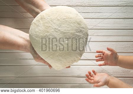 The Hands Of An Old Woman Transmit Bread Dough To The Small Hands Of A Girl. The Intergenerational C