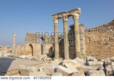Stone Columns And Walls In Ephesus Ancient City. And There Is A Restoration On The Ground