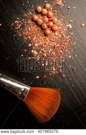 Brushes For Makeup On A Black Background With Beige Powder. Brown Face Powder And Makeup Brushes On 