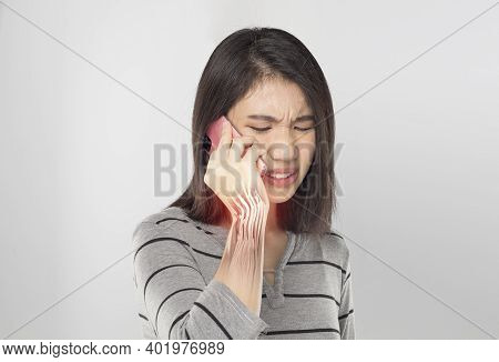 Young Asian Woman Holding Mobile Feel Muscle Wrist Pain In Gray Background
