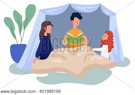 Father And His Children Are Sitting In Self Made Wigwam And Reading A Fairytale. The Concept Of Happ