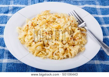 Hash Brown Potatoes On White Plate With Fork