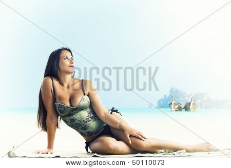 Young woman reaxing on the beach at exotic resort