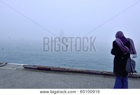 Woman Girl Watching Maiden's Tower In Foggy Morning Istanbul, Turkey