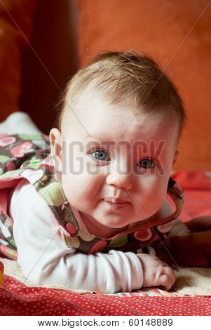 Little Cute Baby Girl Lying On Her Stomach
