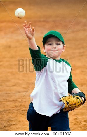 Boy throws baseball during practice