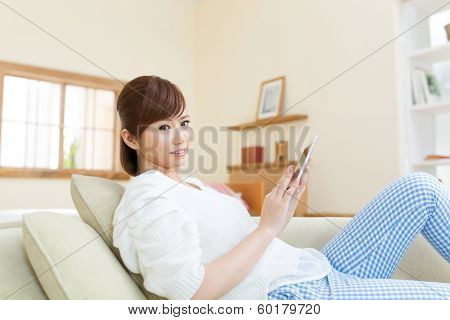 Beautiful asian woman relaxing in the room 