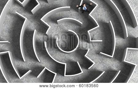 Top view of successful businessman lost in labyrinth