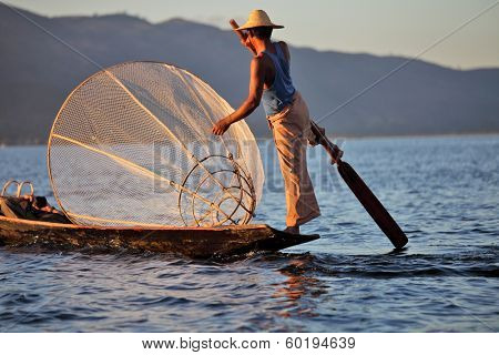 INLE LAKE, MYANMAR ÃÂ¢Ã?Ã? DECEMBER 12, 2013: Fishermen at Inle Lake, Shan State, Myanmar Intha people possess the leg-rowing style and the unique coop-like fishing equipment 