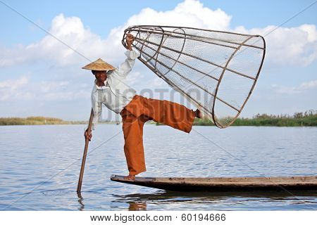 INLE LAKE, MYANMAR ÃÂ¢Ã?Ã? DECEMBER 14, 2013: Fishermen at Inle Lake, Shan State, Myanmar Intha people possess the leg-rowing style and the unique coop-like fishing equipment 