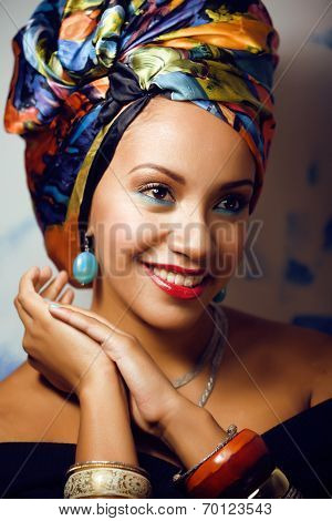 beauty bright african with creative make up, shawl on head like cubian woman