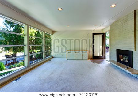 Empty House Interior. Glass Wall Living Room  With Brick Wall And Fireplace