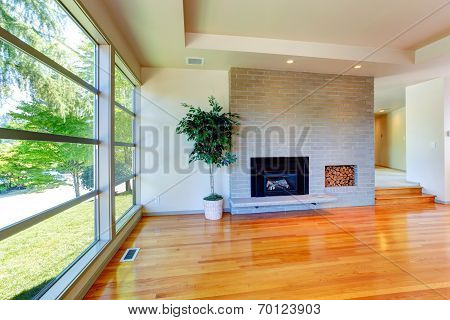 Empty House Interior. Glass Wall Living Room  With Brick Wall And Fireplace