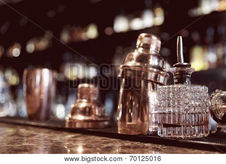 Bartender tools on old style bar counter, toned image