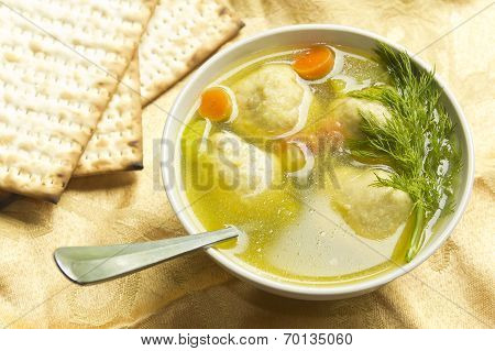 Delicious Matzoh ball soup with crackers wine and dill
