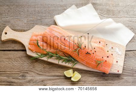 Raw Salmon Steaks On The Wooden Board