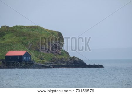 Black house with red roof