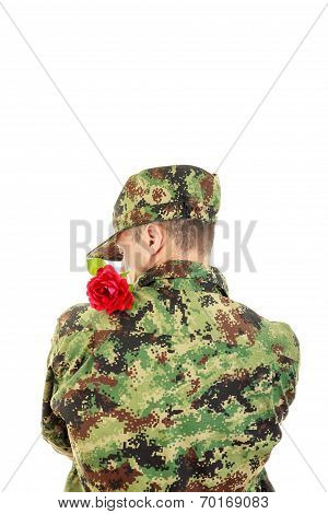 Soldier With Turned Back Holding Red Rose Over Shoulder