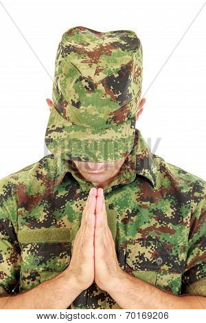 War Soldier Praying In Military Camouflage Uniform With Head Bowed