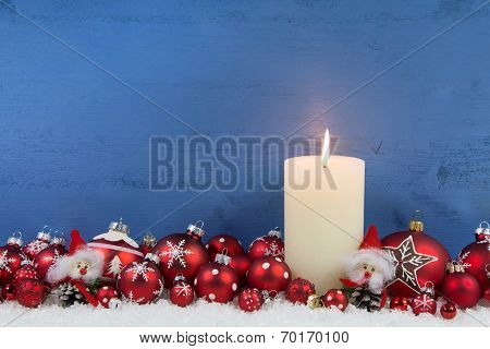 Blue Wooden Christmas Background With A White Candle And Red Balls.