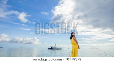 young girl stands on beach