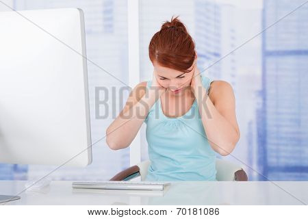 Businesswoman Suffering From Neckache At Computer Desk