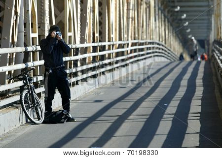 NEW YORK - DECEMBER 21:  A photographer stops to take pictures while on the Queensborough Bridge (59th Street Bridge) during the second day of the transit strike December 21, 2005 in New York City.