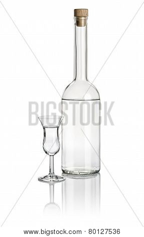 Liquor bottle and high stem glass filled with clear liquid