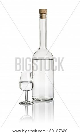 Liquor bottle and snifter filled with clear liquid