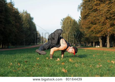 Man Dancing In A Red Cap In The Park