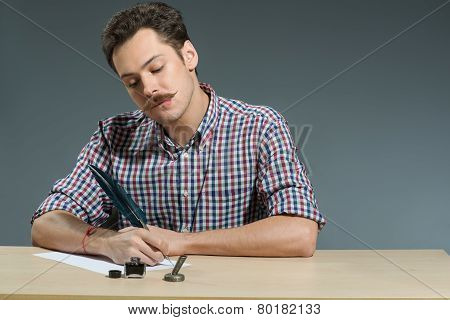 Author Writing with feather close up