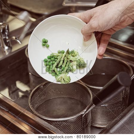 Chef is cooking fresh vegetables, toned picture