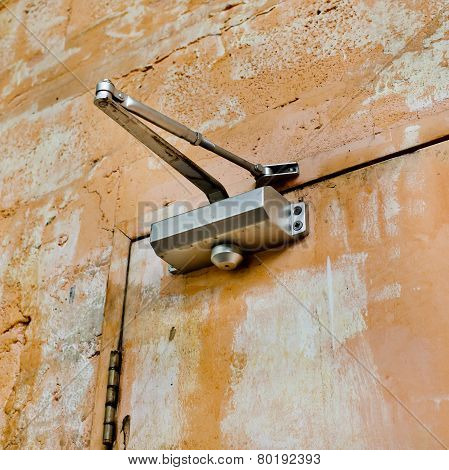 The Device For Automatic Closing A Door With Old And Rust Door And Wall